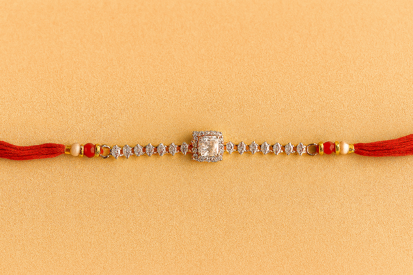 Elegant Square Stone Rakhi with Marquise Crystal Chain and Red Silk Thread