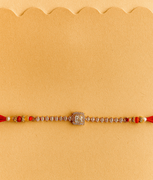 Elegant Square Stone Rakhi with Marquise Crystal Chain and Red Silk Thread